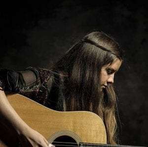 Arielle playing guitar