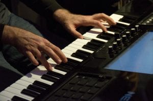 Aaron playing keyboard behind the scenes