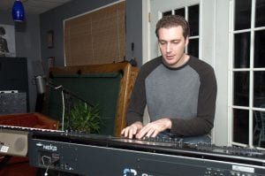 Aaron playing keyboard behind the scenes